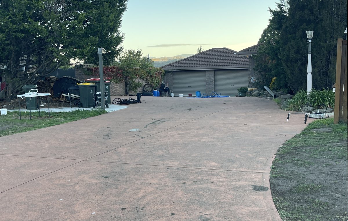 Red concrete driveway before cleaning